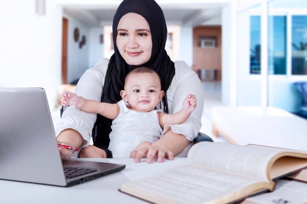 mother and baby in front of laptop
